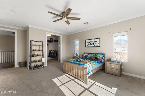 a bedroom with bed and a chandelier