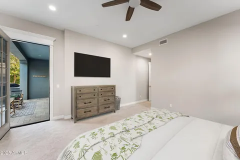 a bedroom with furniture and a flat screen tv