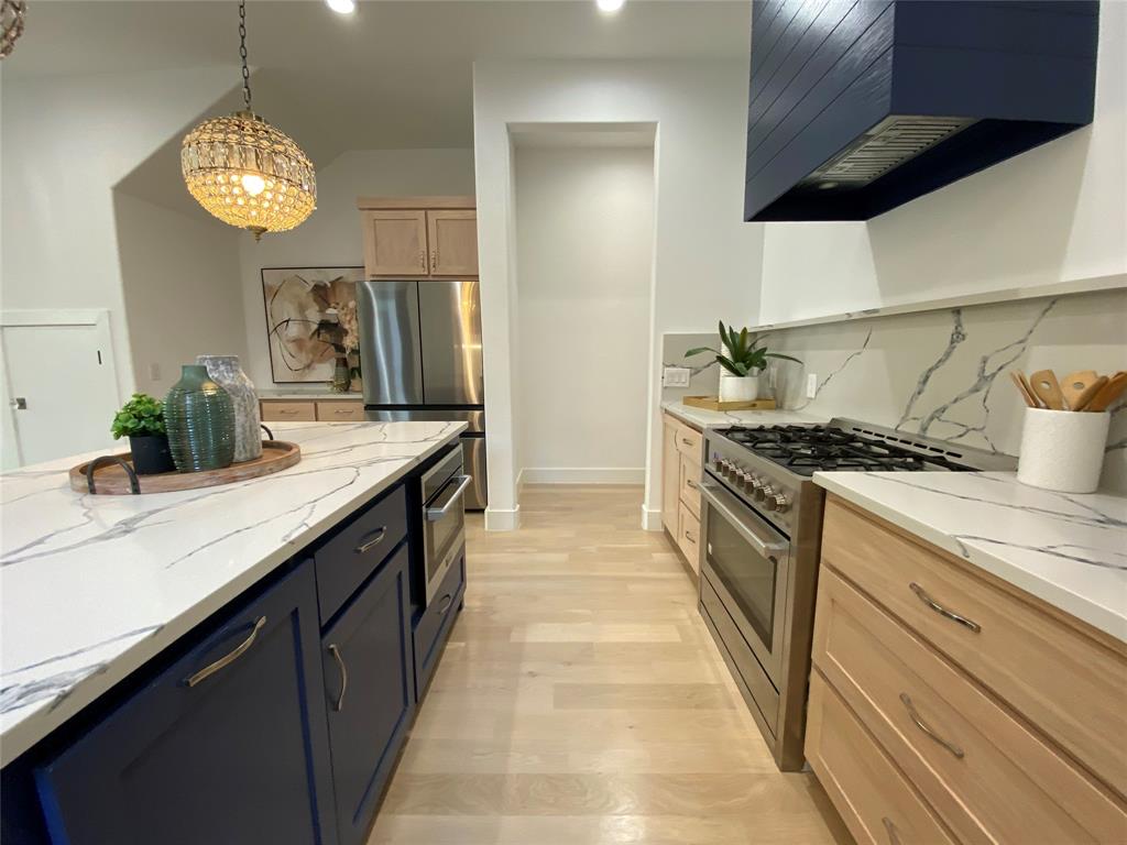 807 South Glasgow Drive Dallas, TX 75223 - Photo 4 of 25 a kitchen with stainless steel appliances granite countertop a sink and a stove