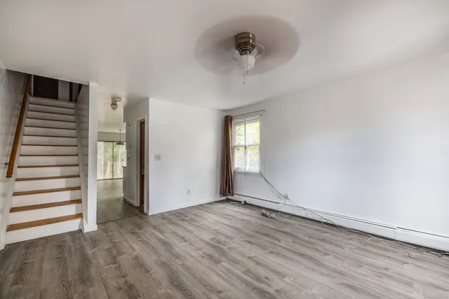 wooden floor in an empty room with a window
