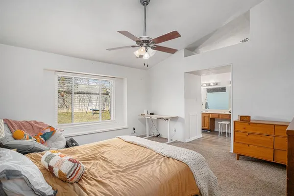 a bedroom with bed and window