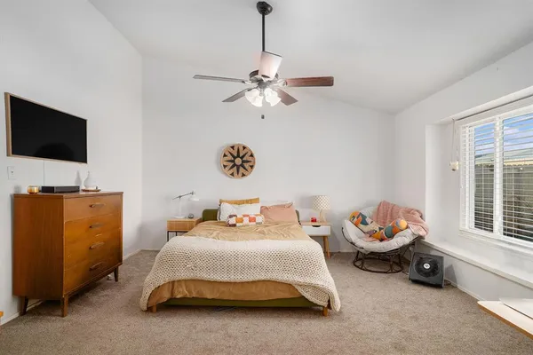 a bedroom with a bed and a window