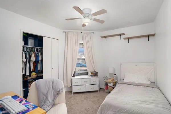 a bedroom with furniture and a window