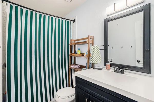 a bathroom with a sink a toilet and mirror