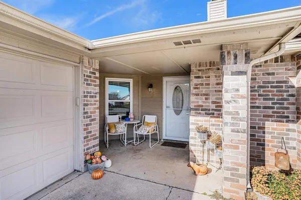 a view of dining room with a table and chairs and potted plants