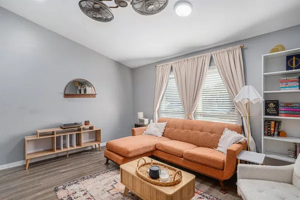 a living room with furniture a rug and a window