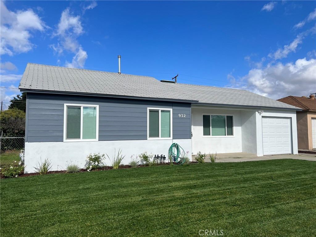a front view of a house with a garden and yard