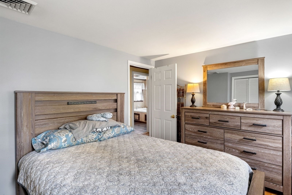 42 Wapping Road Kingston, MA 02364 - Photo 19 of 25 a bedroom with a bed and a dresser