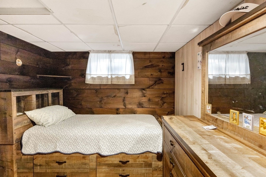 42 Wapping Road Kingston, MA 02364 - Photo 22 of 25 a bedroom with a bed and a large mirror