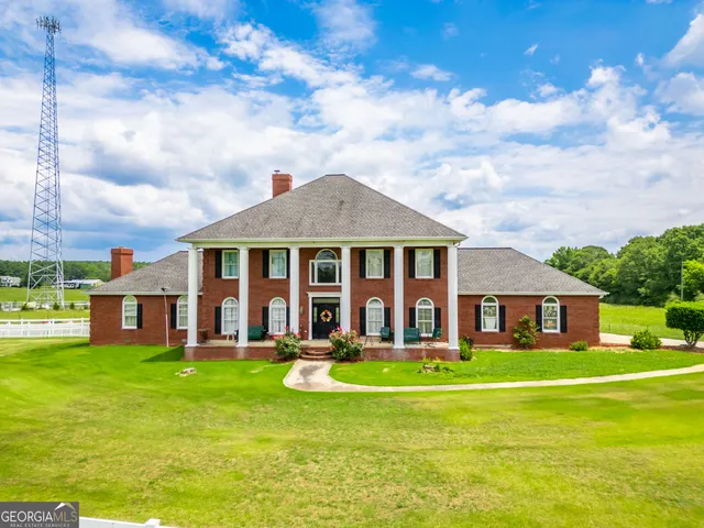 a front view of house with yard and swimming pool