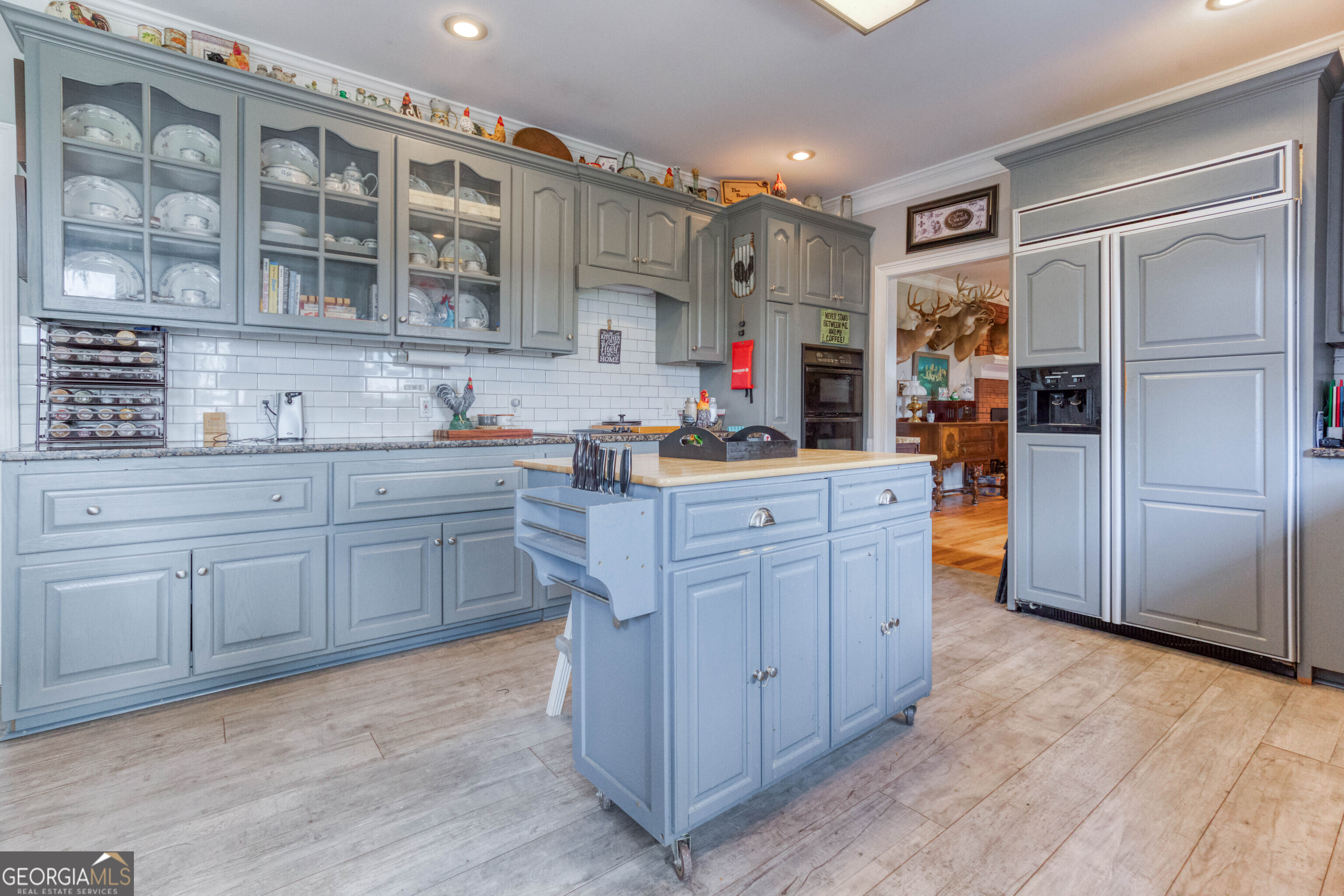 1811 Michael Road Northwest Monroe, GA 30656 - Photo 22 of 43 a kitchen with a sink cabinets and wooden floor