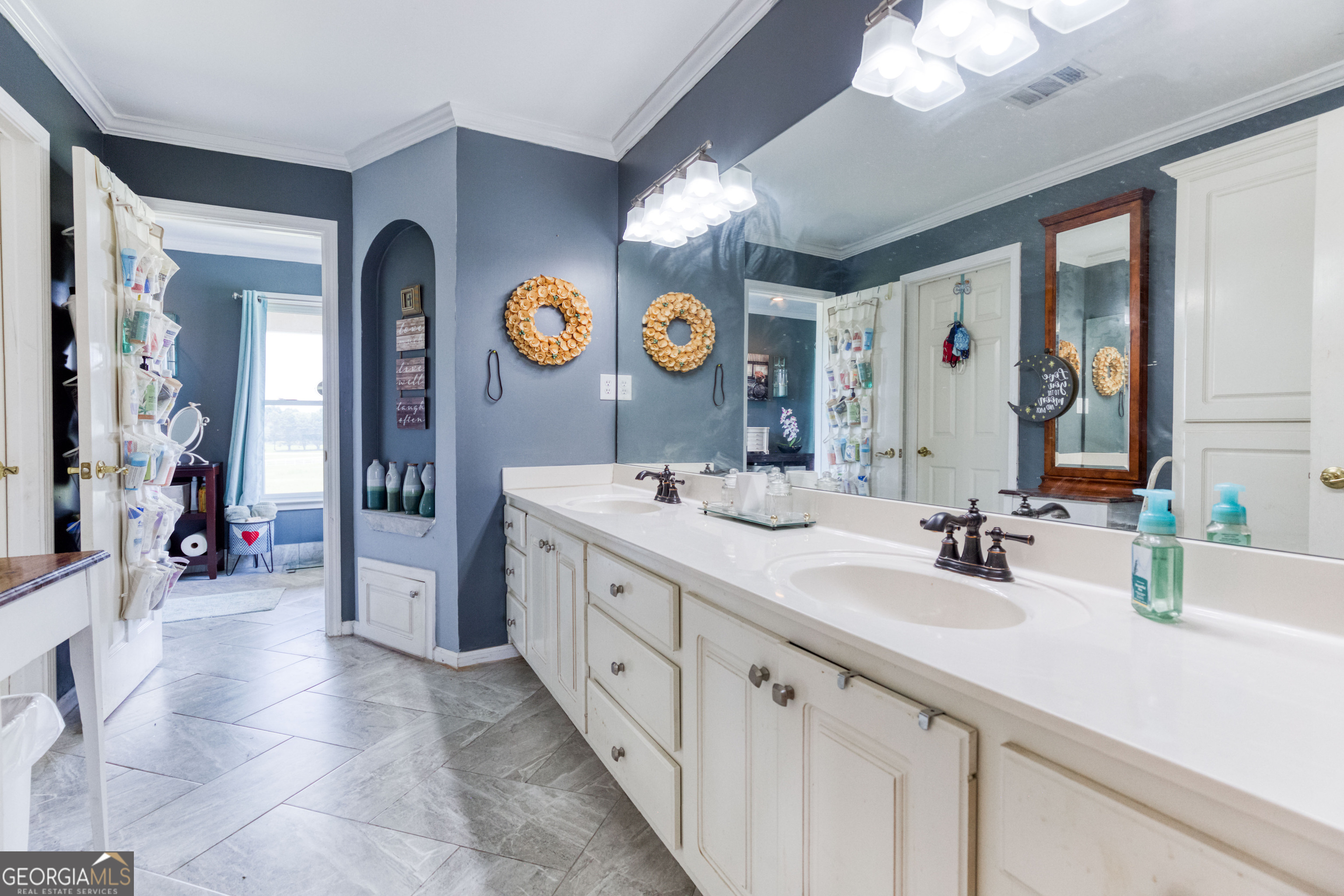 1811 Michael Road Northwest Monroe, GA 30656 - Photo 29 of 43 a bathroom with a sink a vanity a mirror and a shower