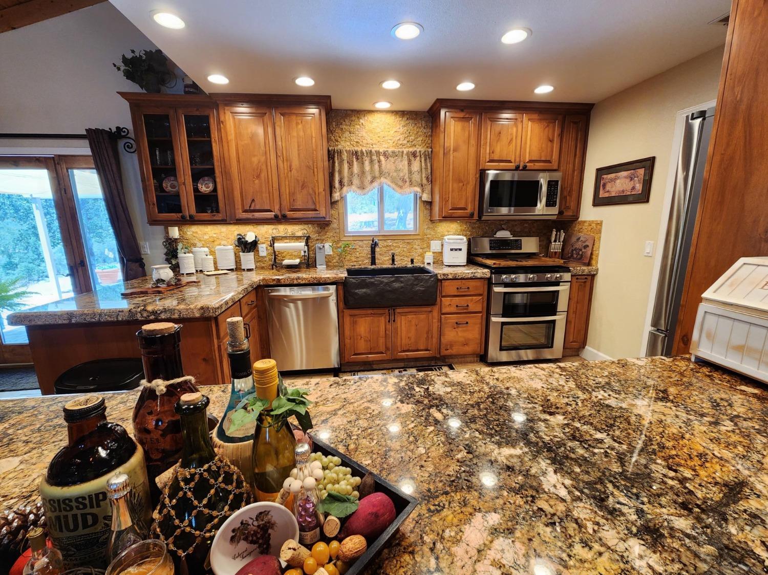 28903 Limestone Circle Coarsegold, CA 93614 - Photo 12 of 59 a kitchen with stainless steel appliances granite countertop sink stove and refrigerator