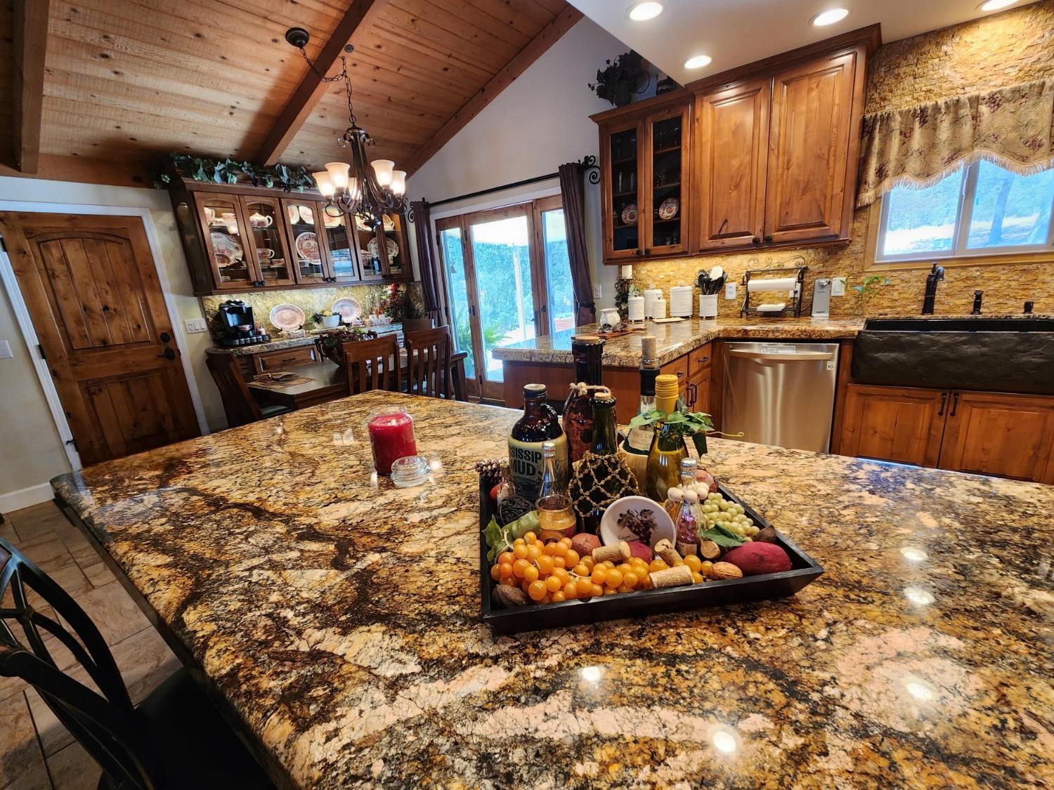28903 Limestone Circle Coarsegold, CA 93614 - Photo 18 of 59 a kitchen with a refrigerator and a stove top oven