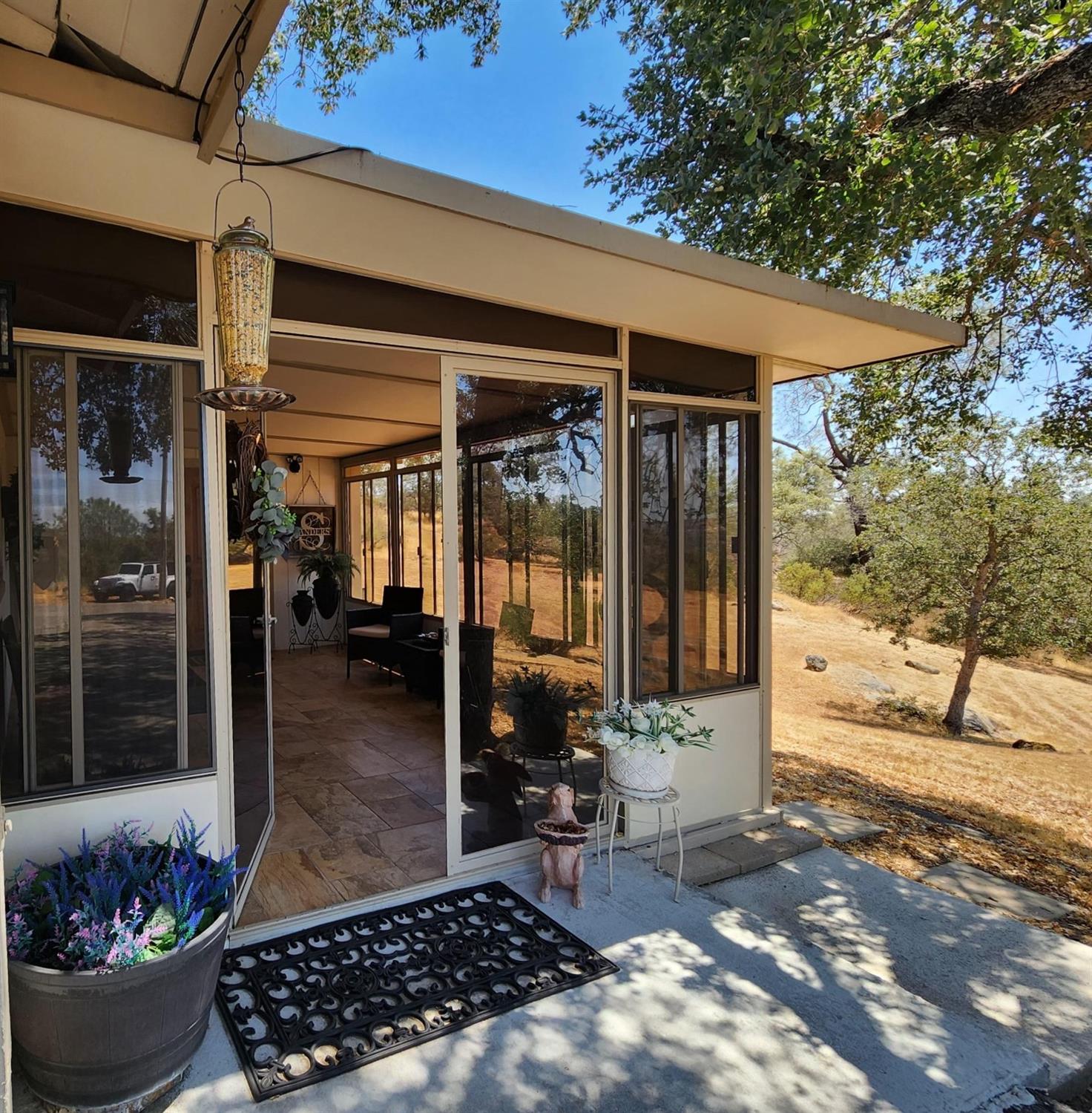 28903 Limestone Circle Coarsegold, CA 93614 - Photo 2 of 59 a view of a porch with potted plants
