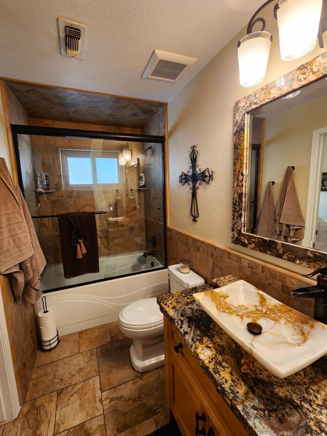 28903 Limestone Circle Coarsegold, CA 93614 - Photo 21 of 59 a bathroom with a sink a toilet and shower