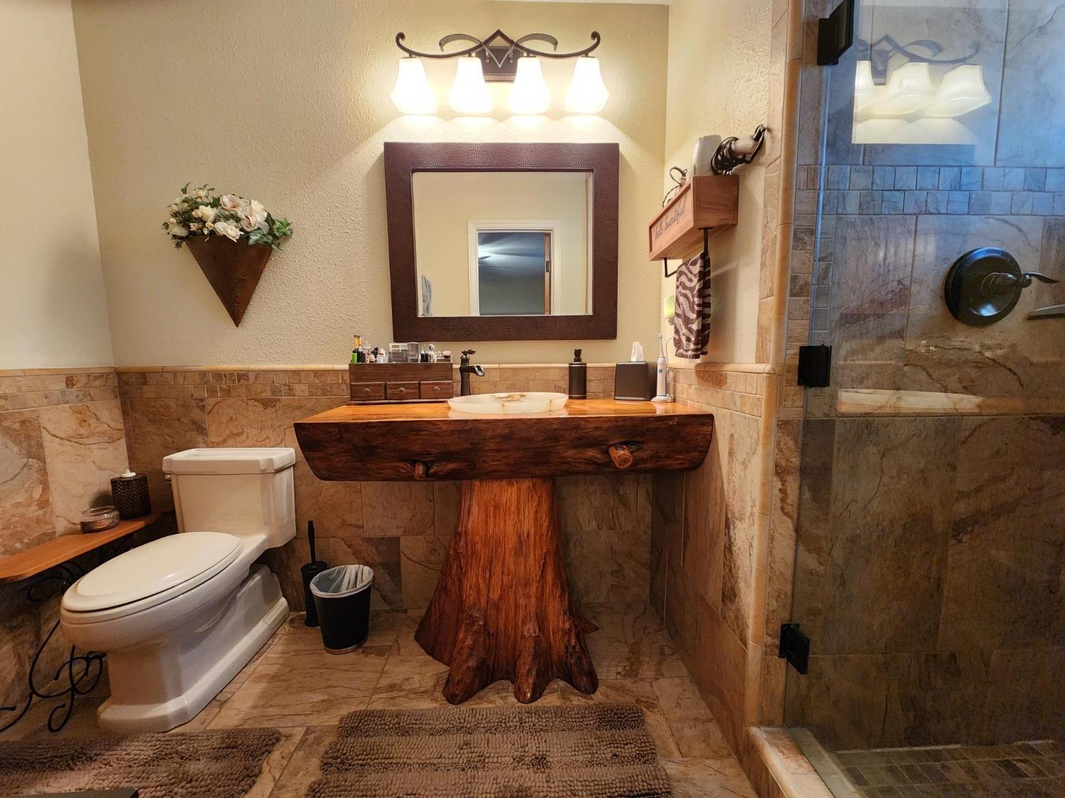 28903 Limestone Circle Coarsegold, CA 93614 - Photo 28 of 59 a bathroom with a toilet sink and mirror