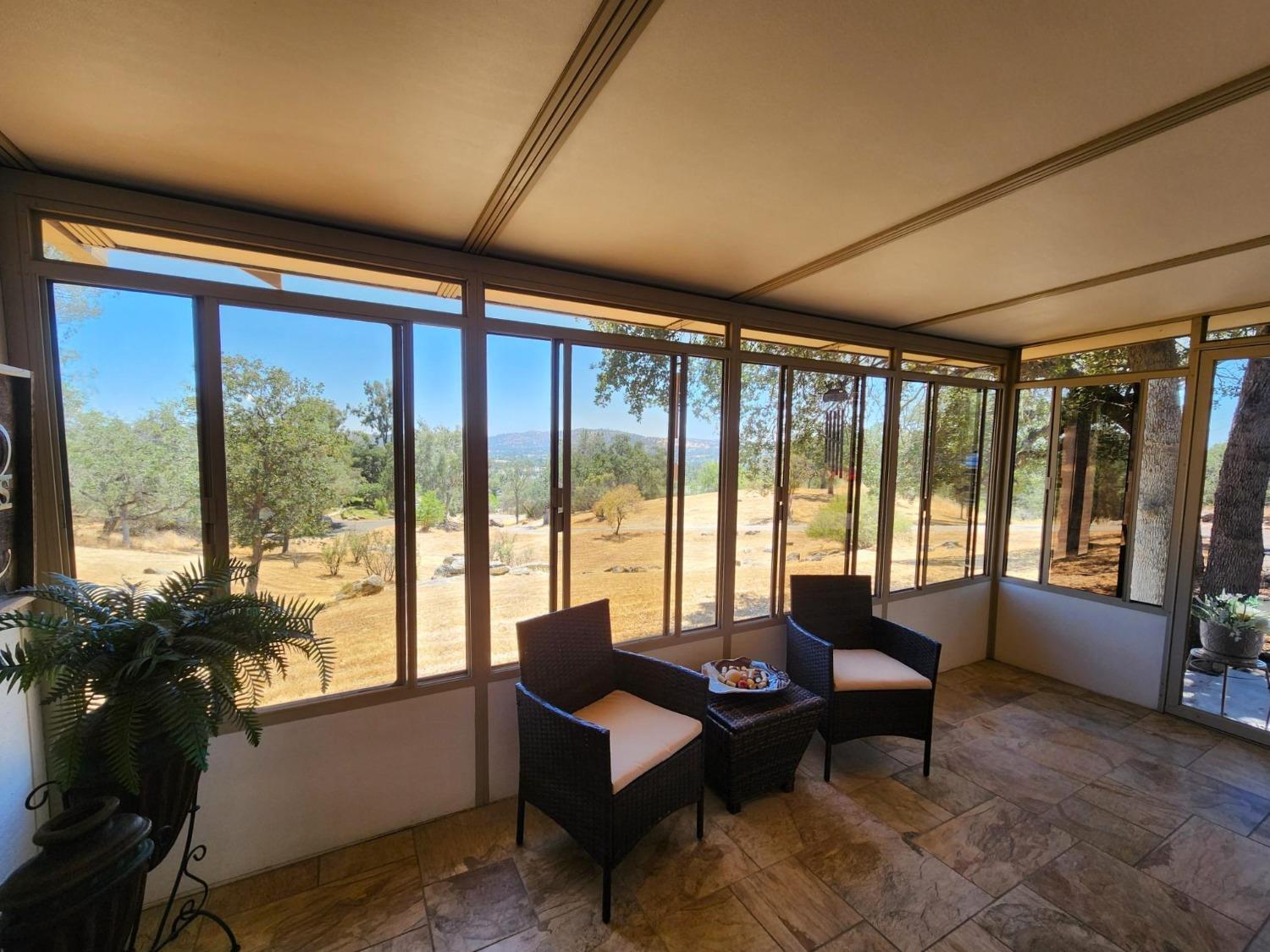 28903 Limestone Circle Coarsegold, CA 93614 - Photo 4 of 59 a living room with furniture and floor to ceiling windows