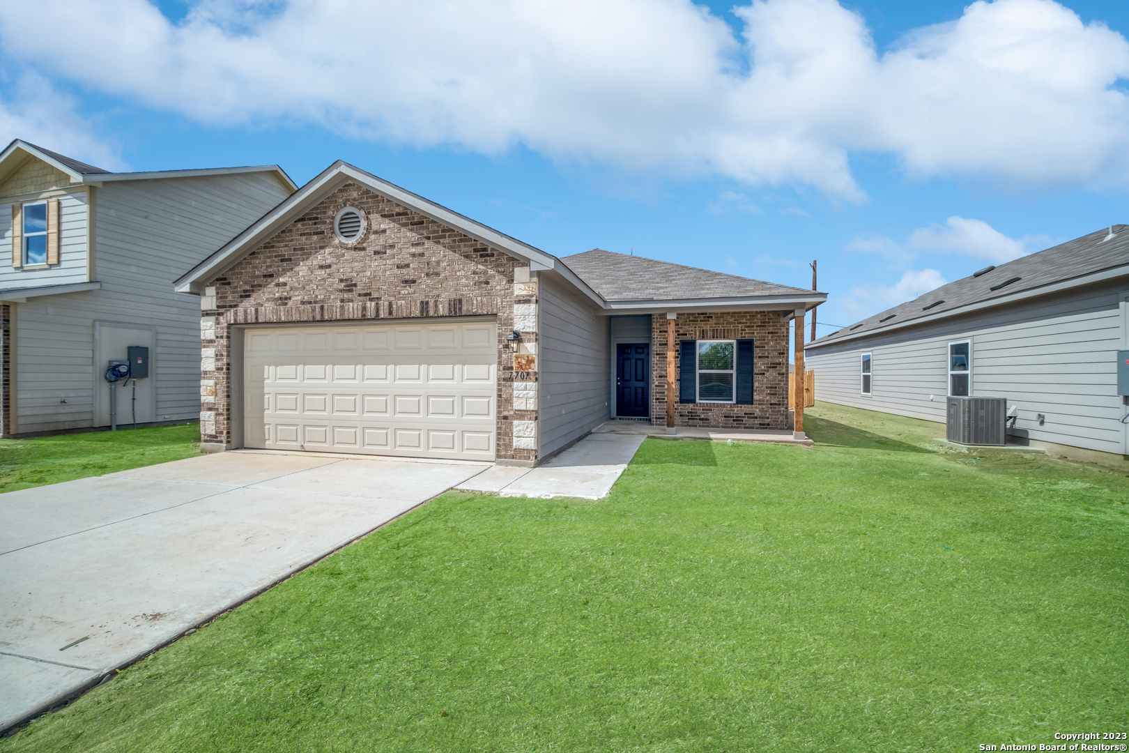 a front view of a house with a yard and garage