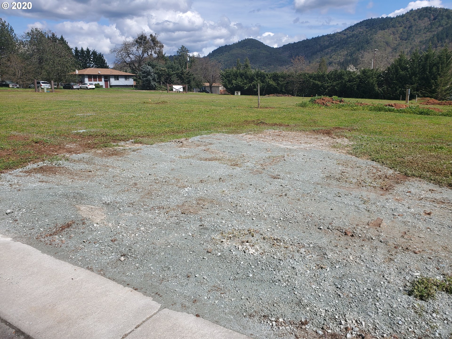 126 Knoll Ridge Court, Unit 20 Myrtle Creek, OR 97457 - Photo 2 of 4 a view of a house with a big yard
