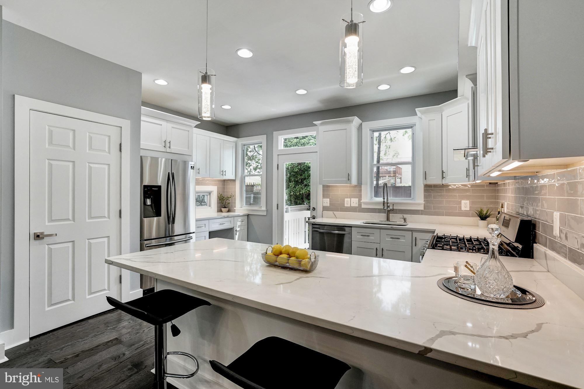 1437 E Street Northeast Washington, DC 20002 - Photo 11 of 39 a kitchen with refrigerator and cabinets