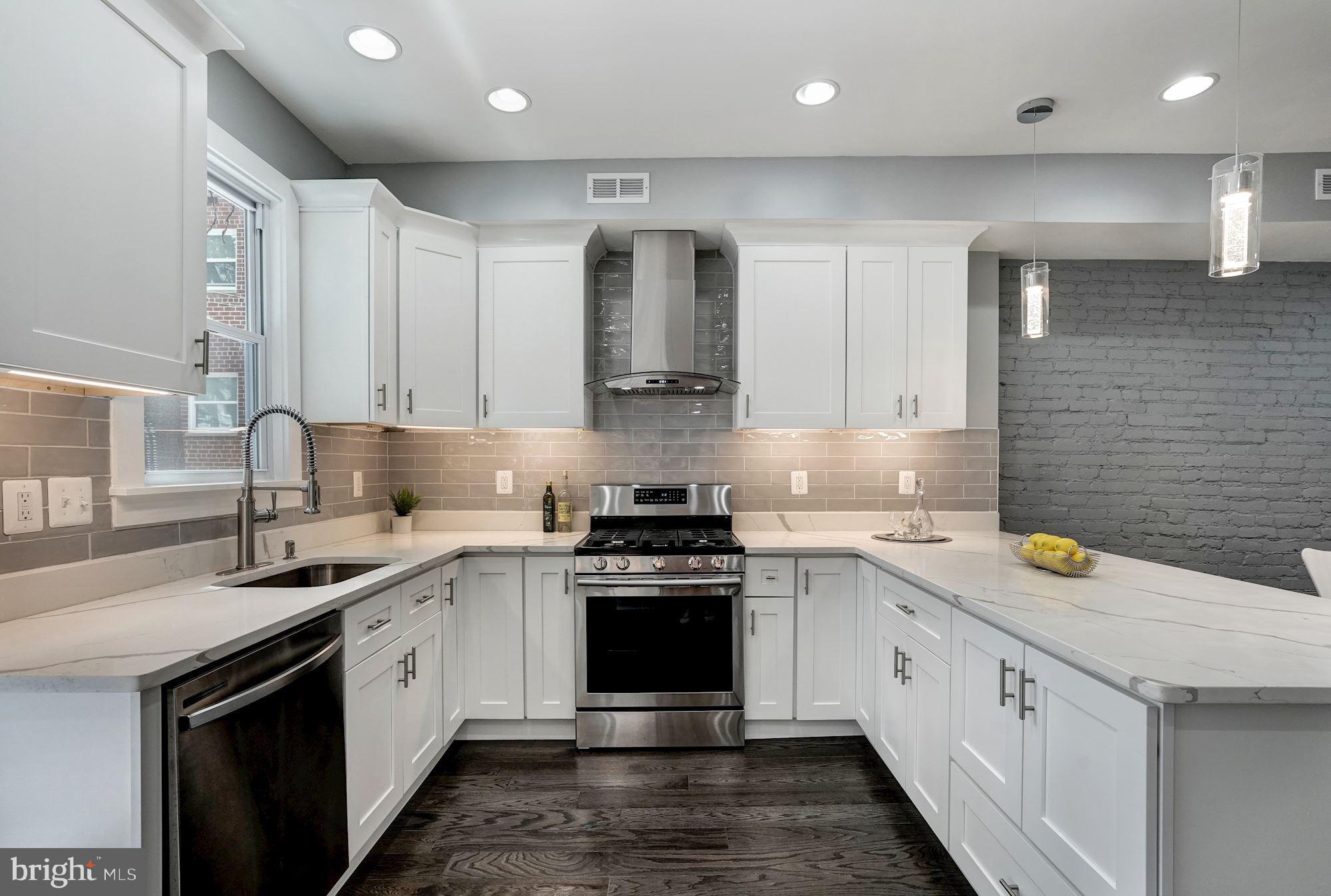 1437 E Street Northeast Washington, DC 20002 - Photo 12 of 39 a kitchen with a sink stove and cabinets