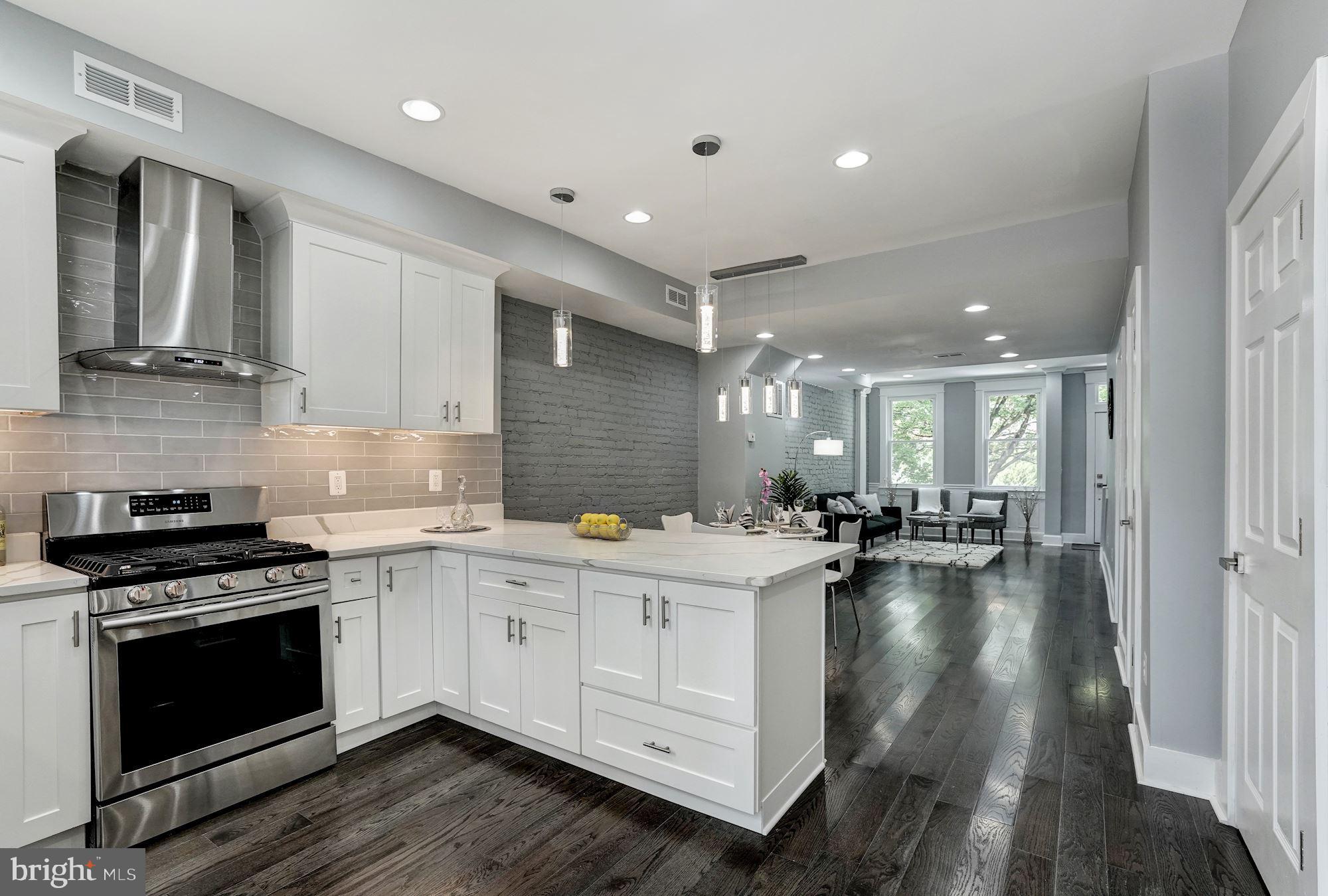 1437 E Street Northeast Washington, DC 20002 - Photo 13 of 39 a kitchen with a stove a sink and wooden floor