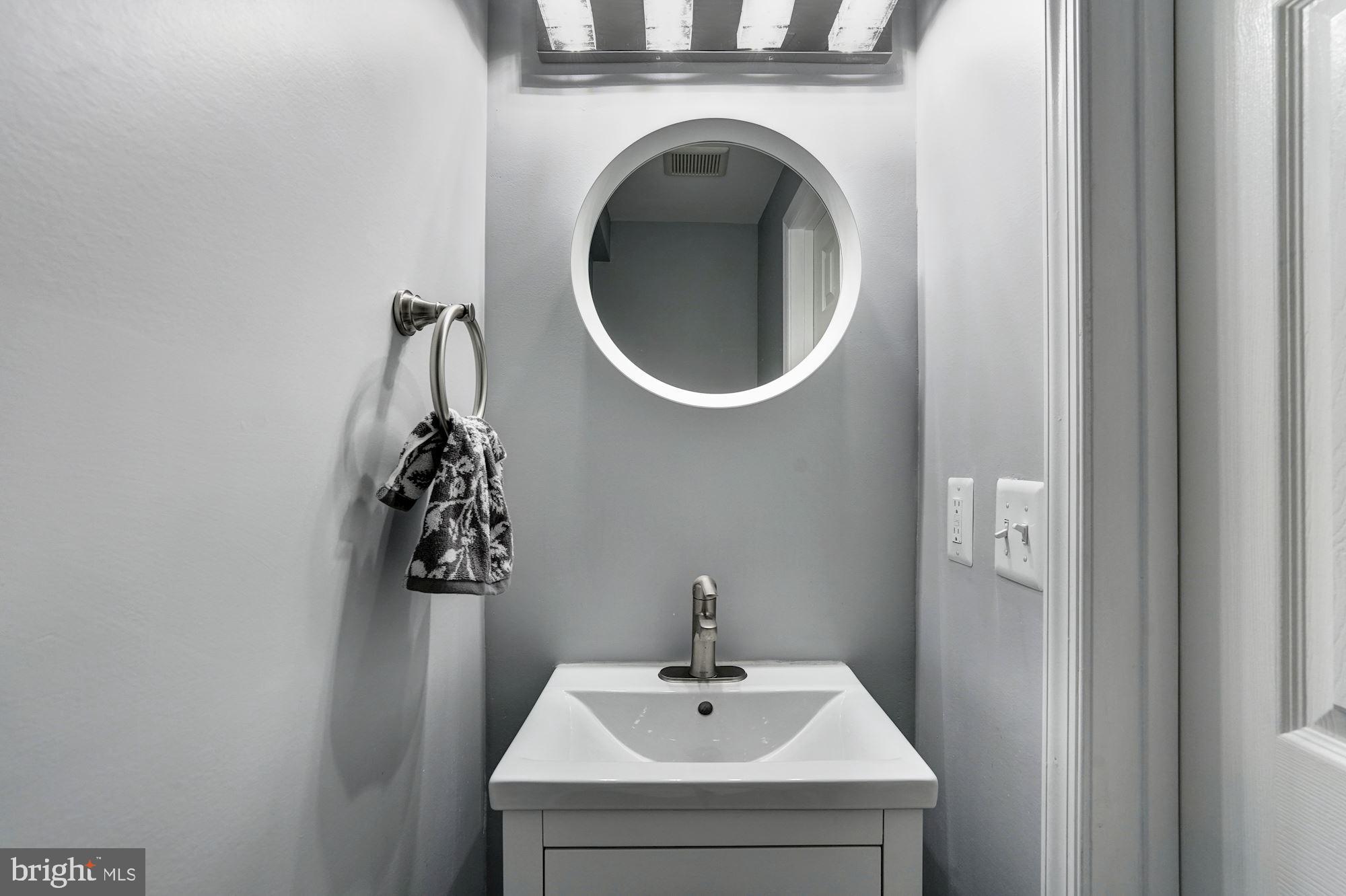 1437 E Street Northeast Washington, DC 20002 - Photo 15 of 39 a bathroom with a sink and a mirror