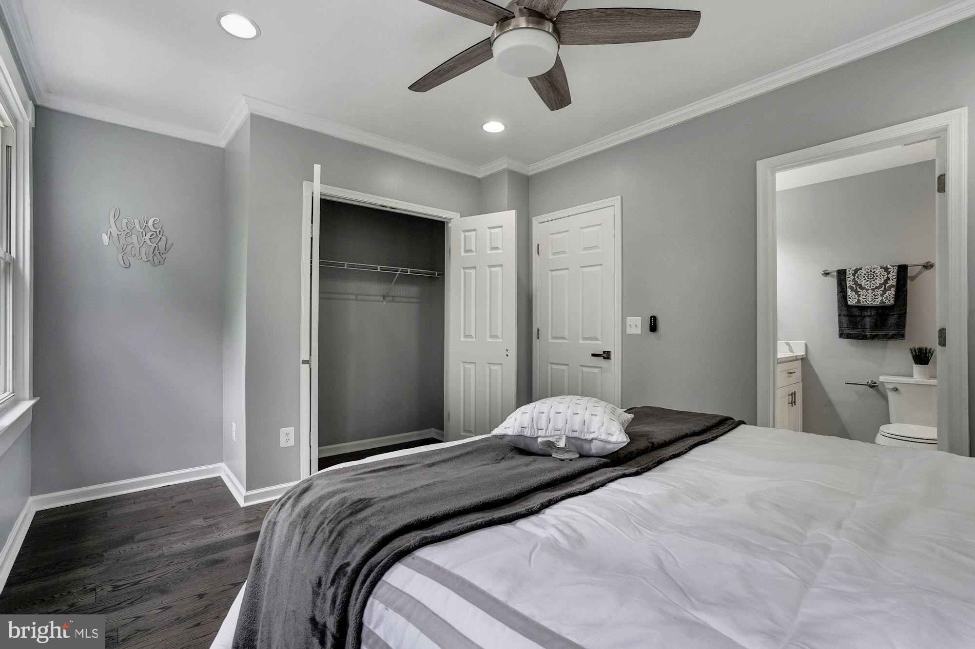 1437 E Street Northeast Washington, DC 20002 - Photo 17 of 39 a bedroom with a bed and a chandelier