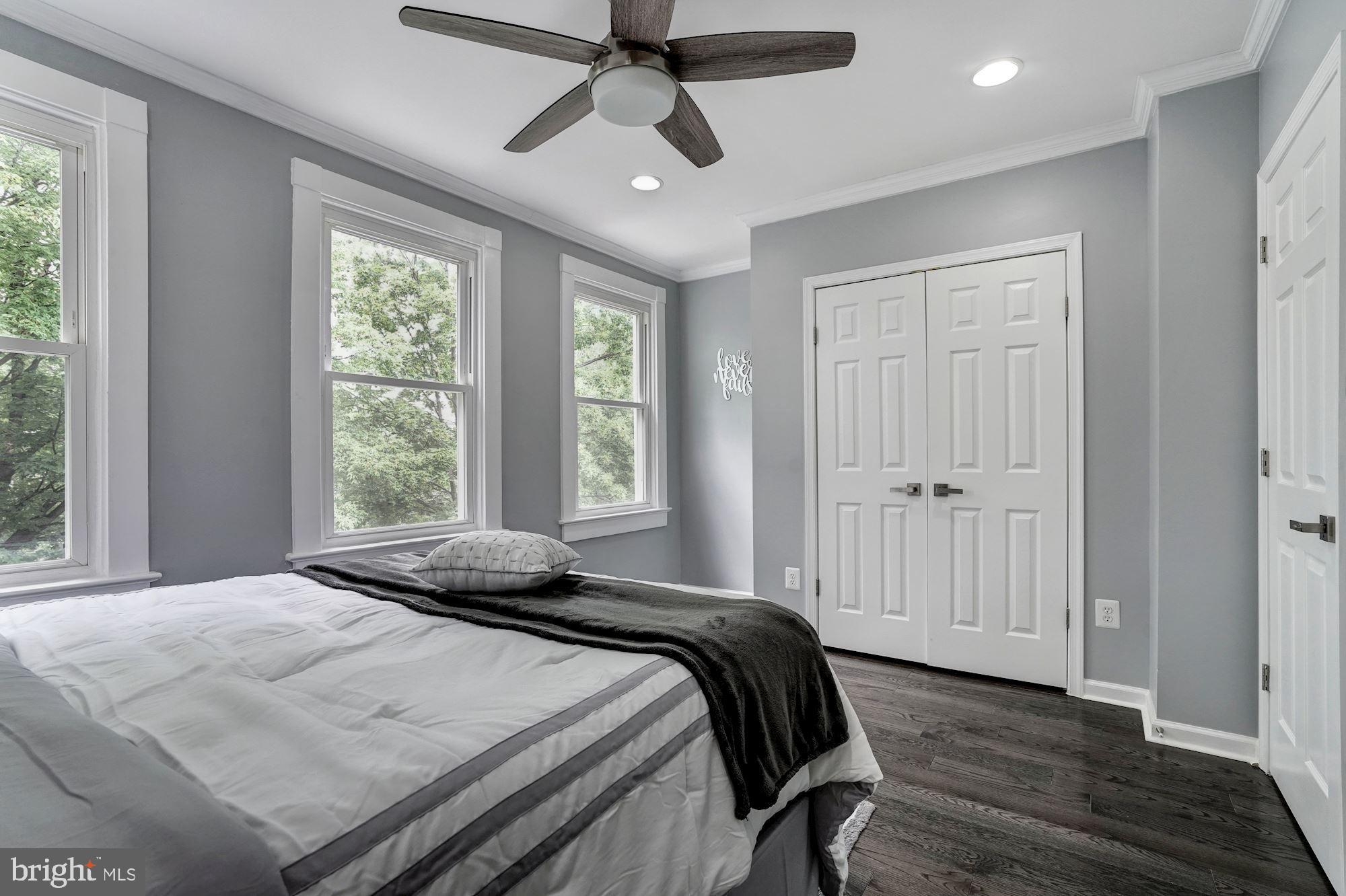 1437 E Street Northeast Washington, DC 20002 - Photo 18 of 39 a bedroom with a bed and wooden floor