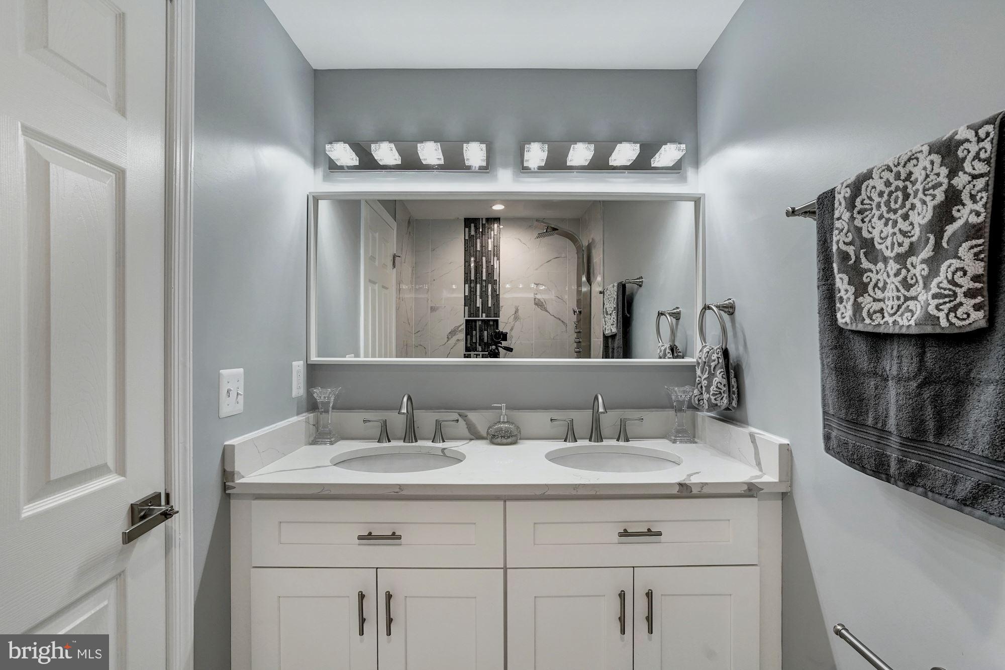 1437 E Street Northeast Washington, DC 20002 - Photo 19 of 39 a bathroom with a sink and a mirror