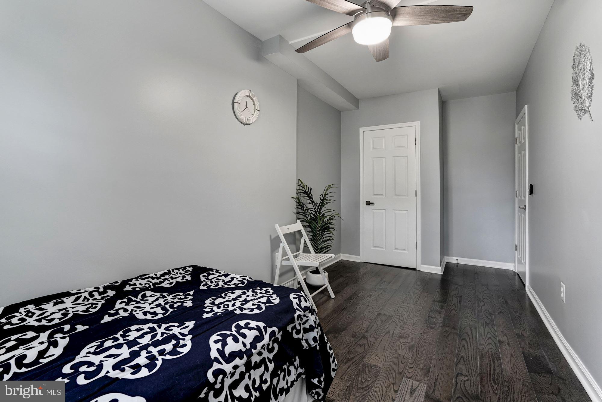 1437 E Street Northeast Washington, DC 20002 - Photo 25 of 39 a bedroom with a bed and a chandelier