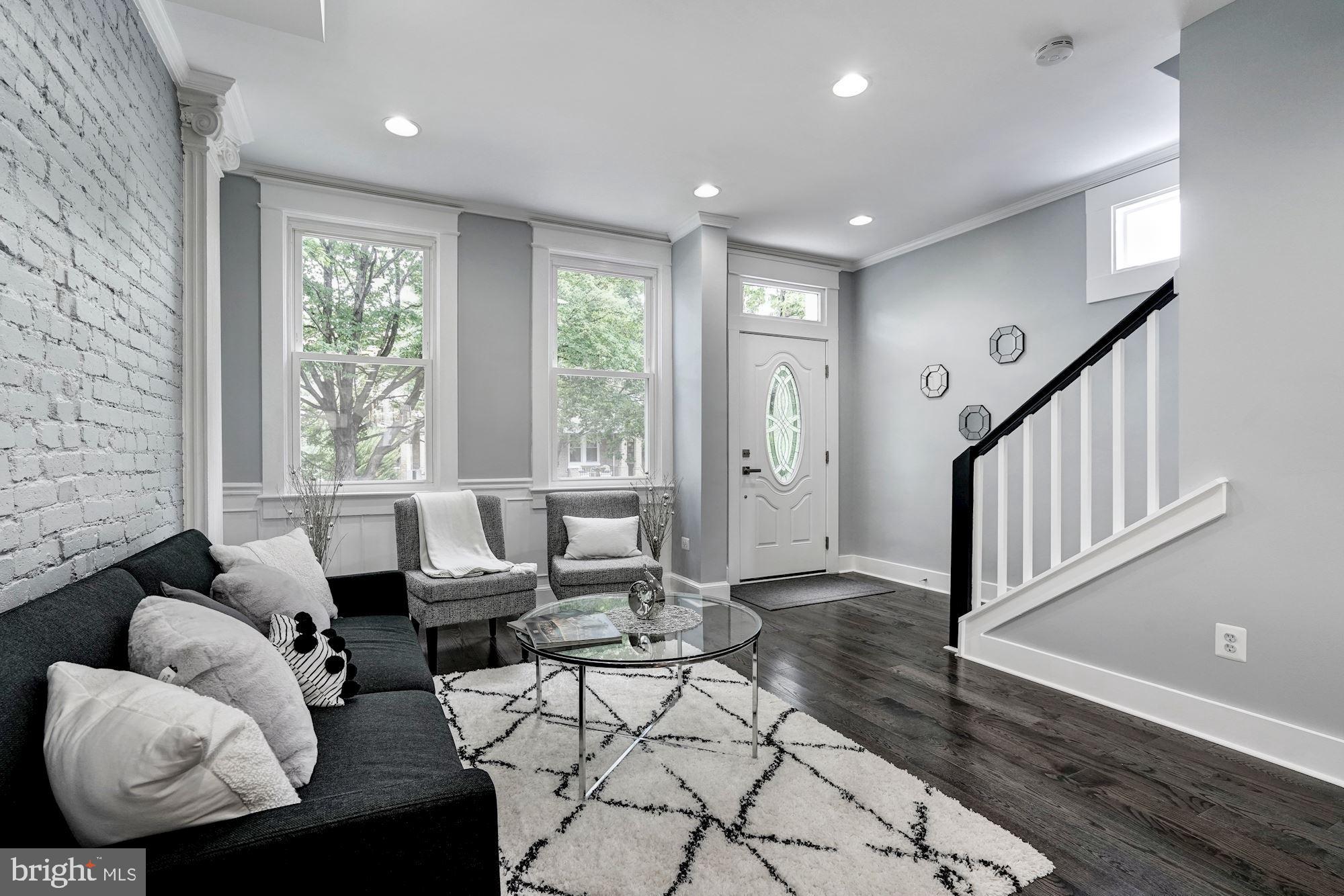 1437 E Street Northeast Washington, DC 20002 - Photo 4 of 39 a living room with furniture and floor to ceiling windows