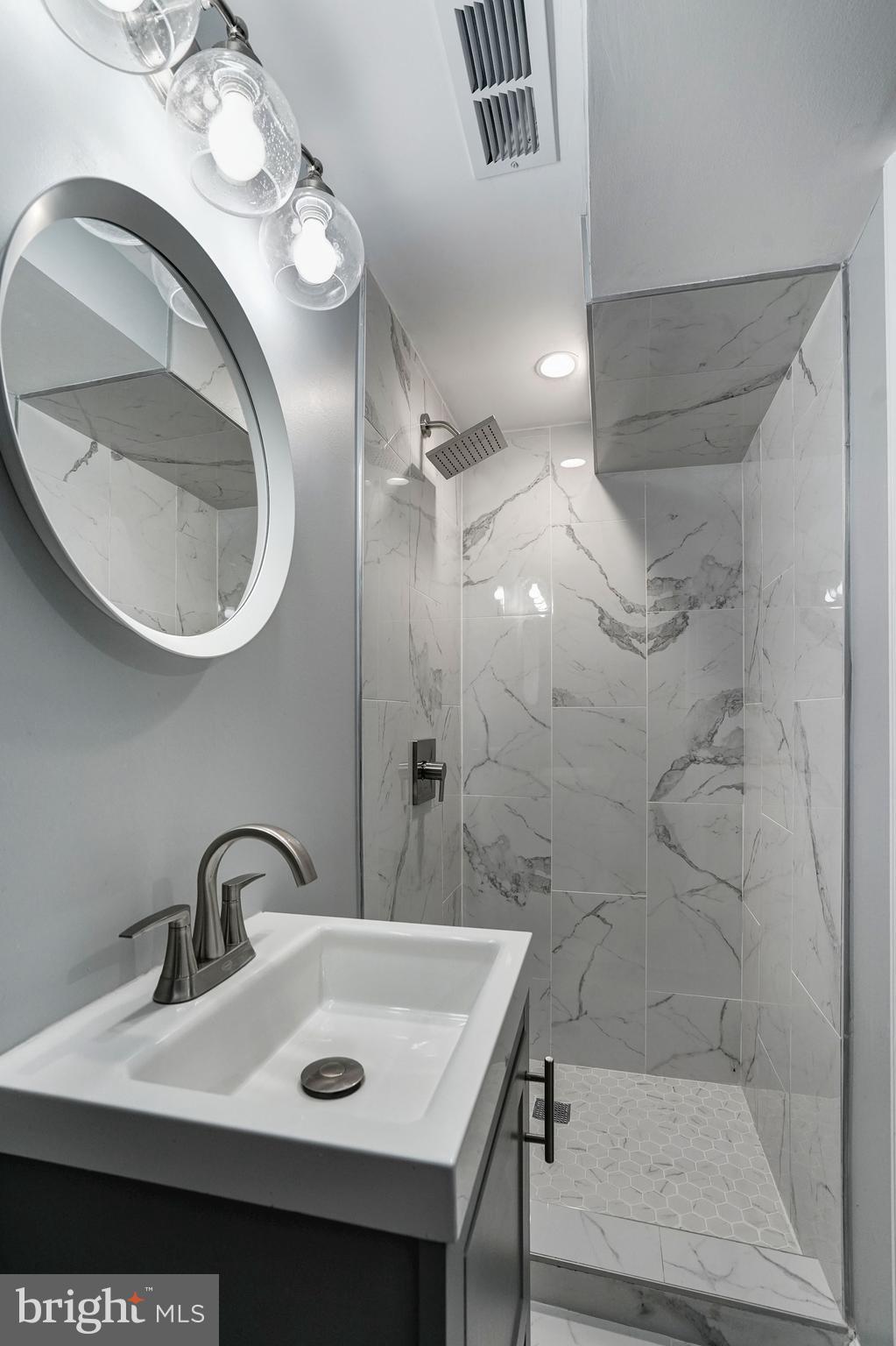 1437 E Street Northeast Washington, DC 20002 - Photo 34 of 39 a bathroom with a sink a toilet and a mirror