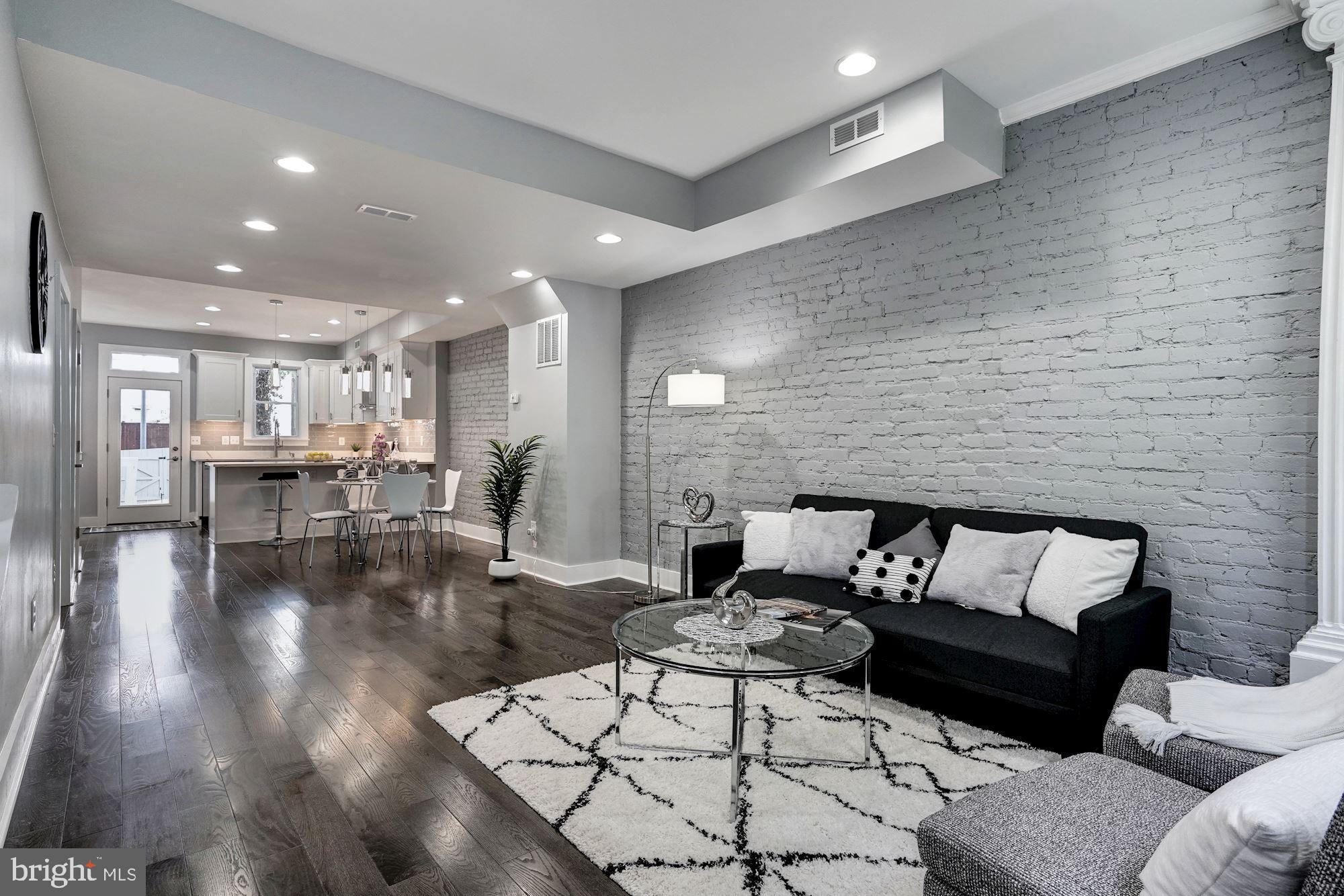 1437 E Street Northeast Washington, DC 20002 - Photo 7 of 39 a living room with furniture and a dining table with wooden floor
