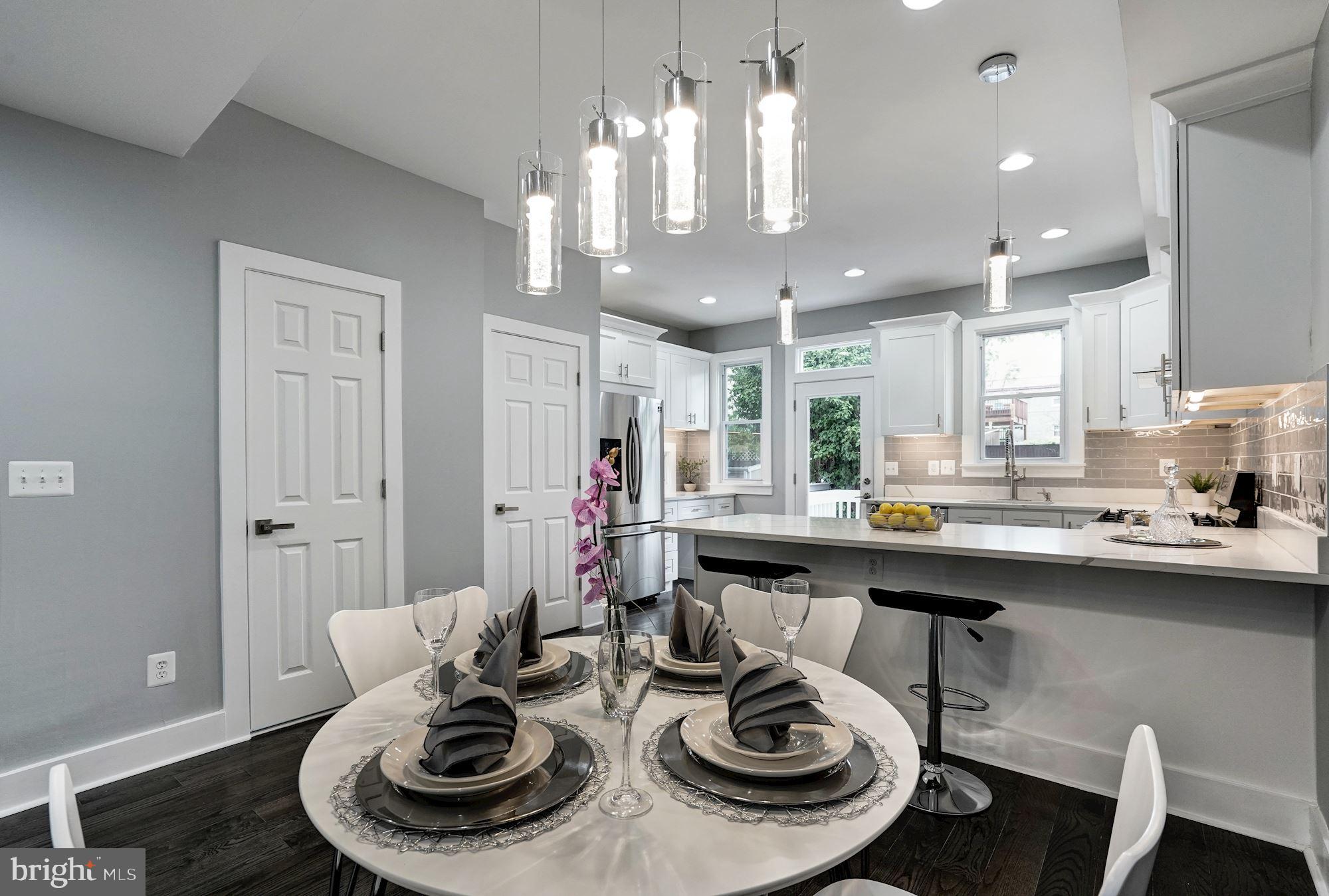 1437 E Street Northeast Washington, DC 20002 - Photo 9 of 39 a kitchen with a dining table and chairs