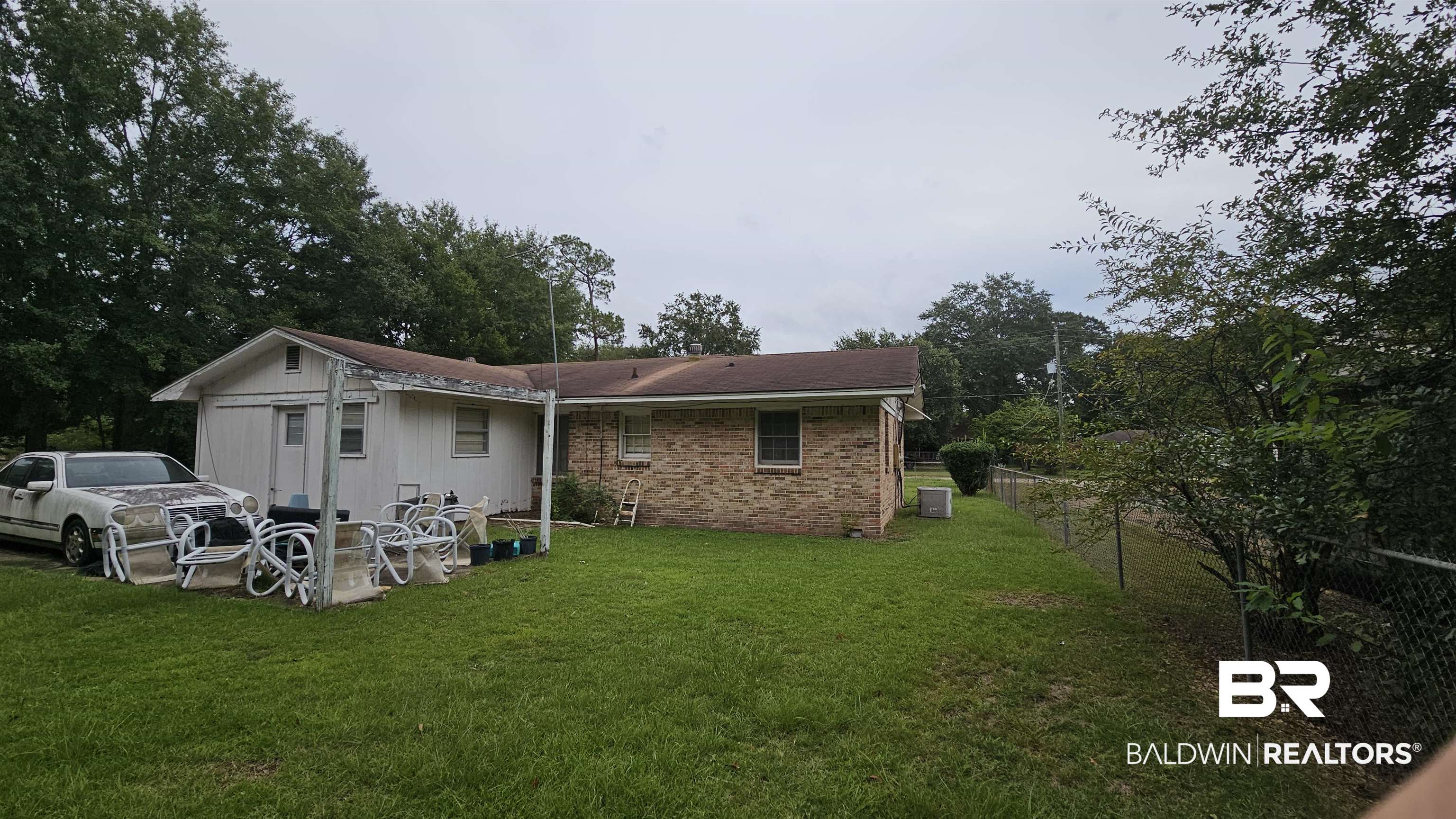 216 6th Avenue Atmore, AL 36502 - Photo 27 of 34 Back of house with cooling unit and a lawn