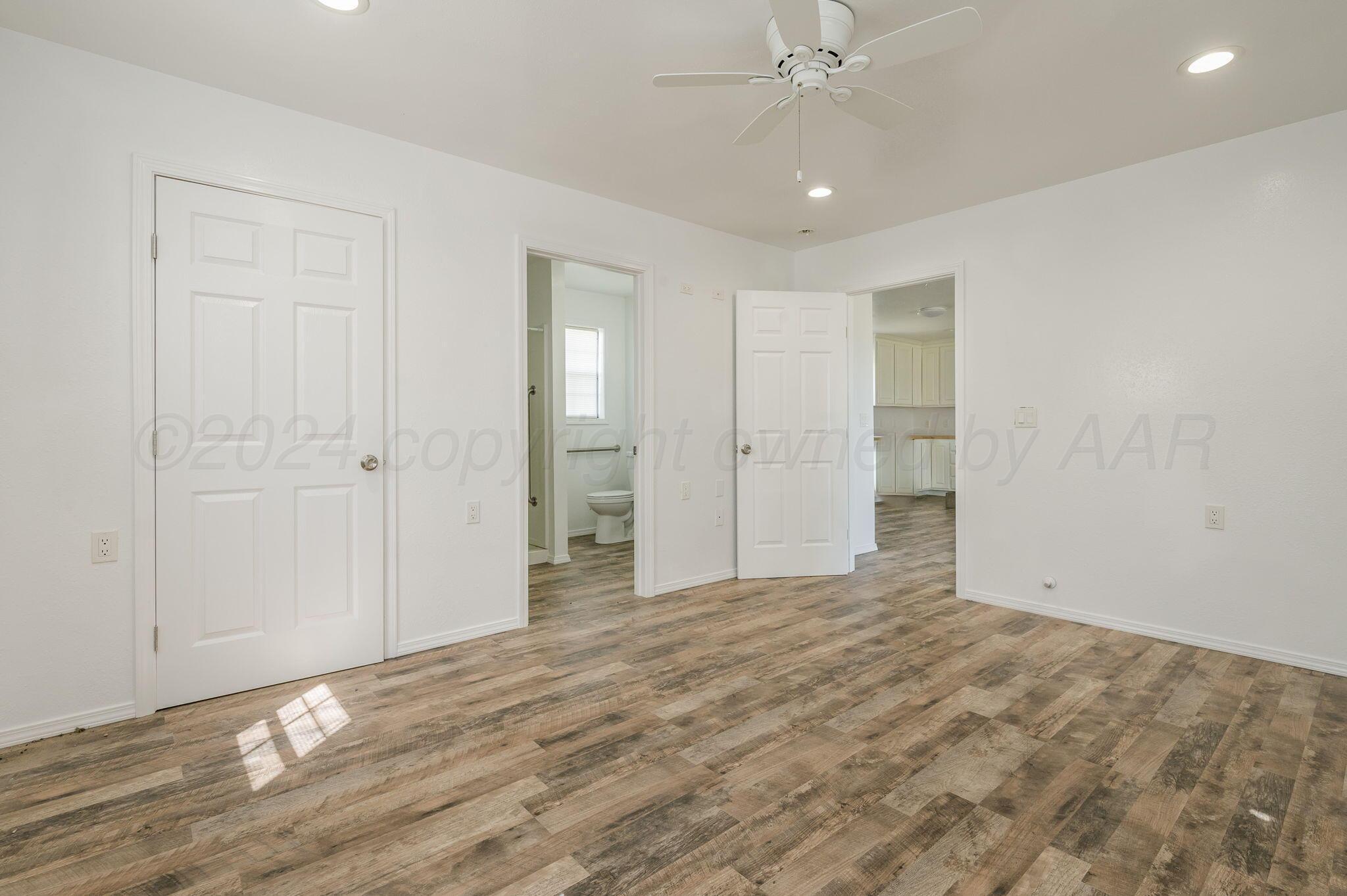 621 Plainview Street Howardwick, TX 79226 - Photo 9 of 18 a view of an empty room with wooden floor