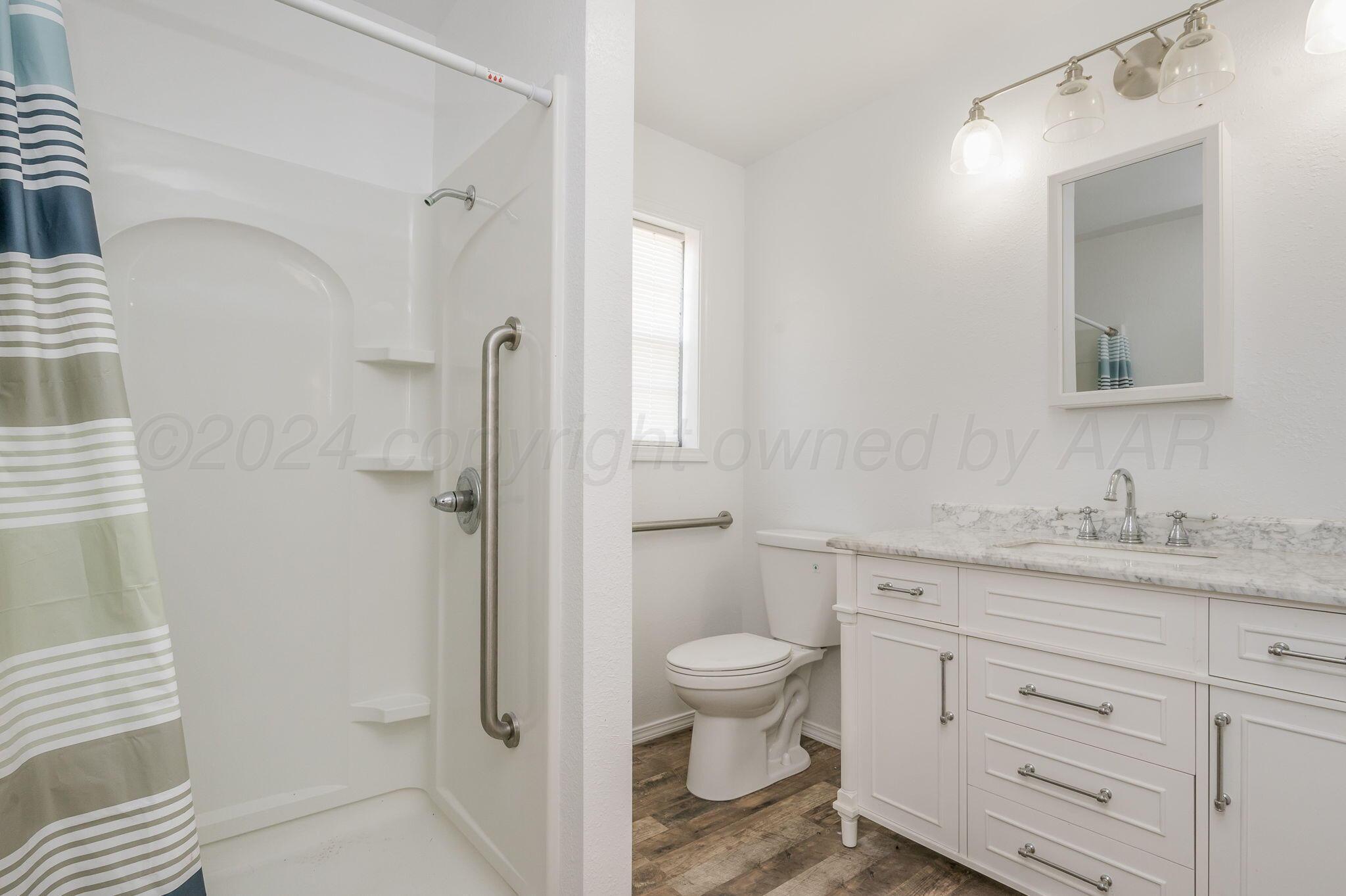 621 Plainview Street Howardwick, TX 79226 - Photo 10 of 18 a bathroom with a granite countertop sink toilet and shower