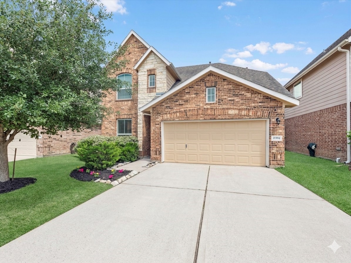 21554 Rainfall Park Drive Spring, TX 77388 - Photo 2 of 33 Welcome home! Charming brick home with a well-maintained front yard, featuring a two-car garage and a neatly landscaped low maintenance lawn.