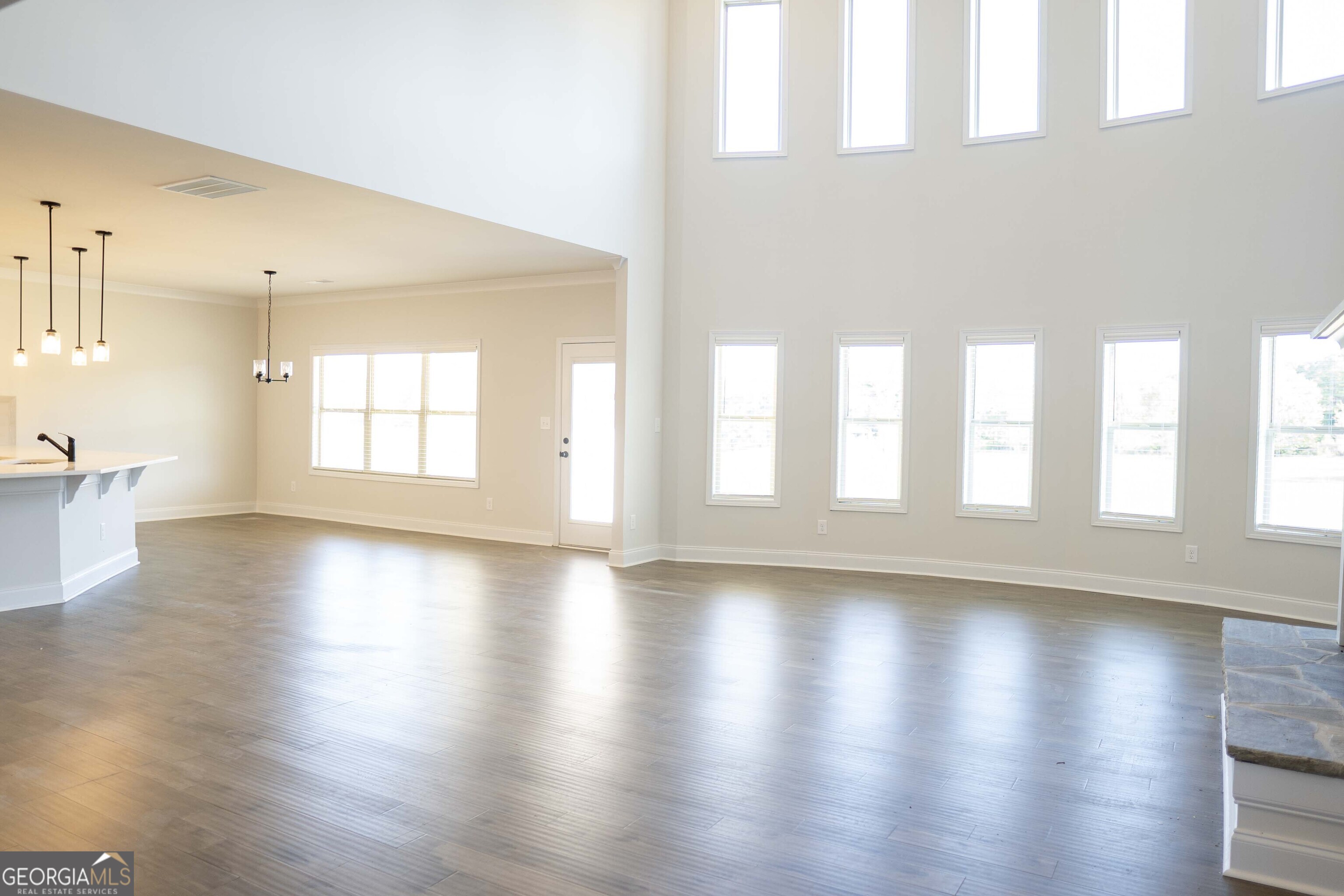 600 Beaver Court Perry, GA 31069 - Photo 13 of 48 a view of an empty room with wooden floor and a window