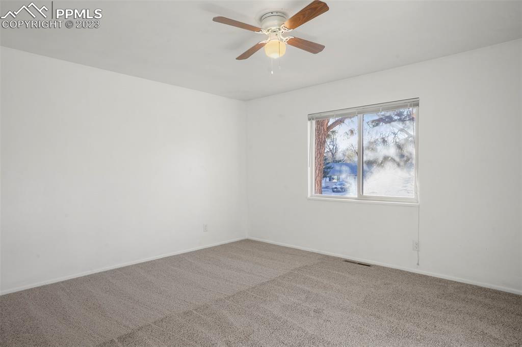 1159 Peterson Road Colorado Springs, CO 80915 - Photo 11 of 22 an empty room with a window and a fan