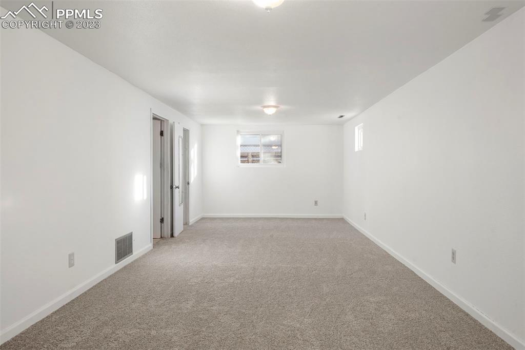 1159 Peterson Road Colorado Springs, CO 80915 - Photo 15 of 22 an empty room with a empty space and windows