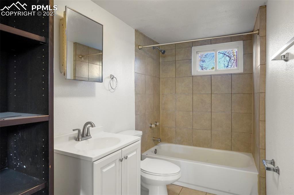 1159 Peterson Road Colorado Springs, CO 80915 - Photo 17 of 22 a bathroom with a bathtub shower sink mirror and toilet