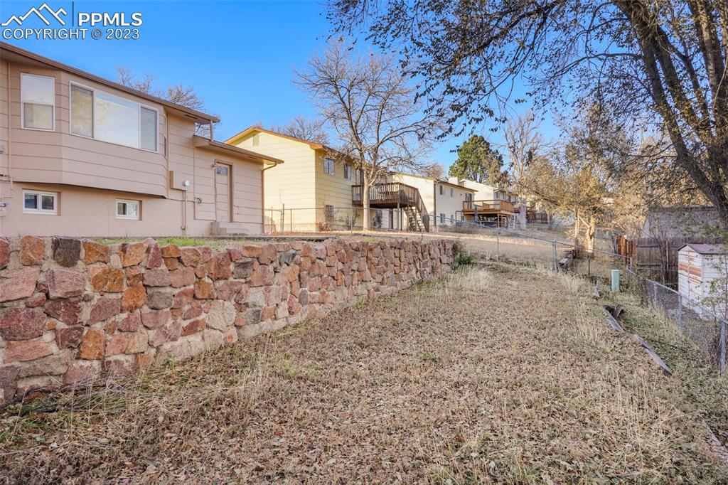 1159 Peterson Road Colorado Springs, CO 80915 - Photo 21 of 22 a view of a house with a yard