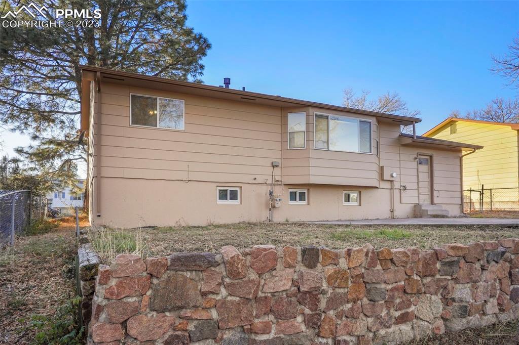 1159 Peterson Road Colorado Springs, CO 80915 - Photo 22 of 22 a backyard of a house with lots of green space