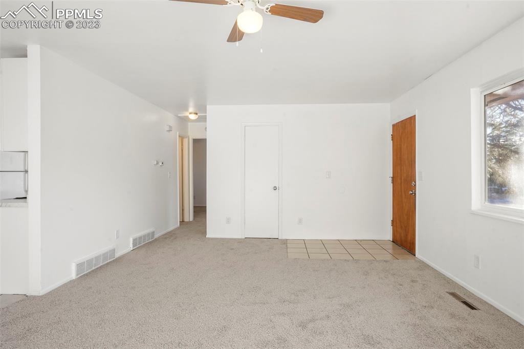 1159 Peterson Road Colorado Springs, CO 80915 - Photo 3 of 22 an empty room with windows