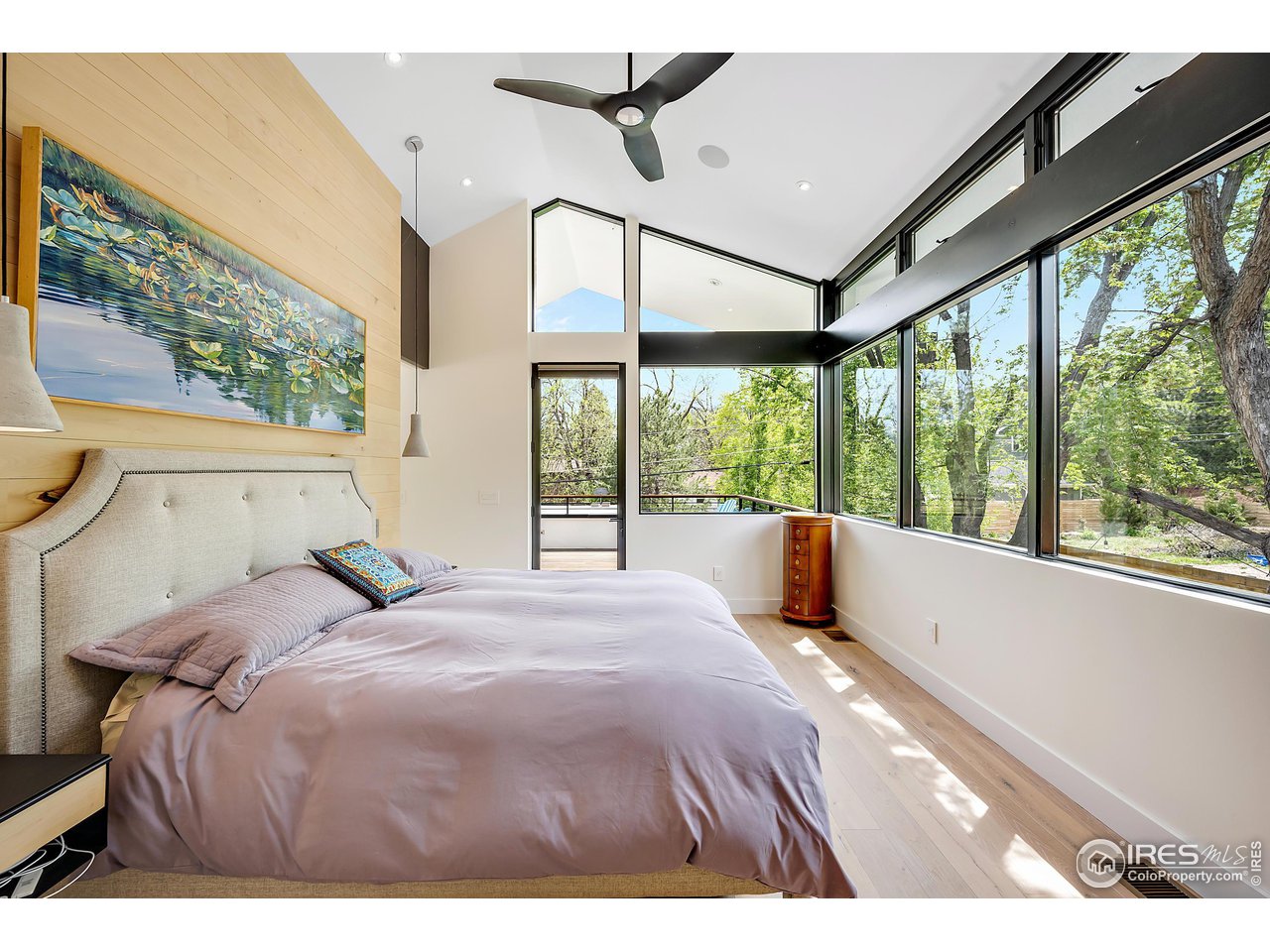 550 Iris Avenue Boulder, CO 80304 - Photo 18 of 40 a bedroom with a large bed and a large window