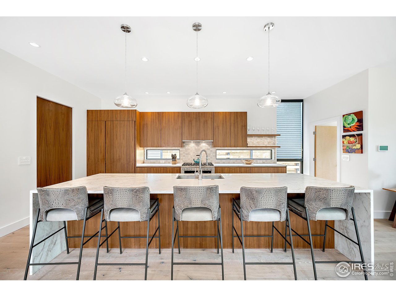 550 Iris Avenue Boulder, CO 80304 - Photo 6 of 40 a kitchen with a dining table chairs and white cabinets