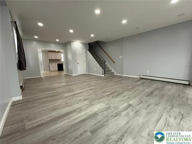 a view of an empty room with wooden floor